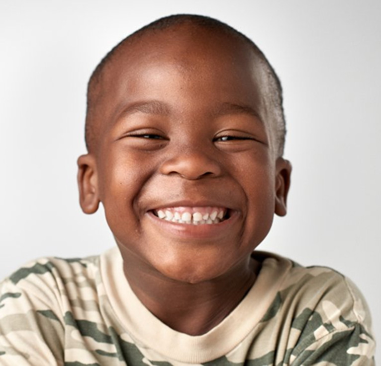 Boy smiling brightly on white background