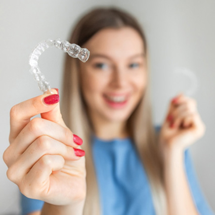 Child in Naperville smiling with Invisalign clear aligners