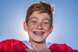 Young athlete with braces smiling.